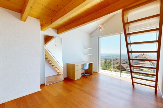 empty room featuring light wood-style flooring, an office area, and a wood ceiling with exposed beams