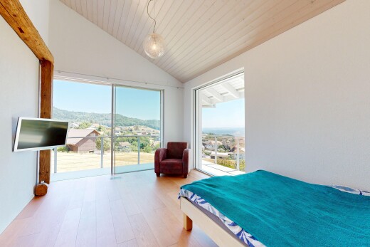 room / bedroom featuring light wood finished floors, access to exterior, and a vaulted wood ceiling