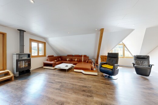 living room with a wood stove, wood finished floors, recessed lighting, healthy amount of natural light, and vaulted ceiling