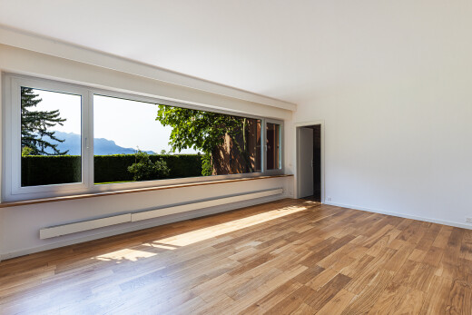 pièce vide avec radiateur à plinthe, wood finish floor, sol en finition bois, inside property, et drywall