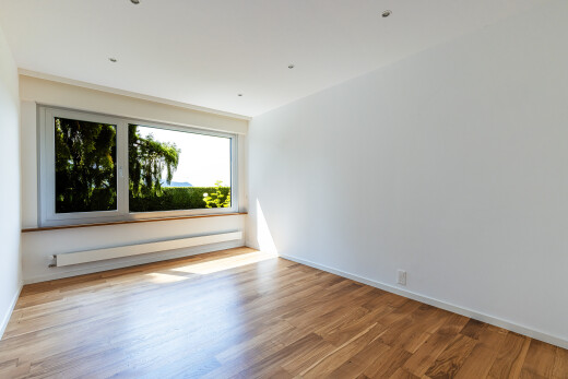 pièce vide avec inside property, radiateur à plinthe, wood finish floor, sol en finition bois, et natural light