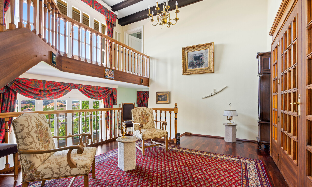 salon avec high ceiling, plafond haut, wood finish floor, sol en finition bois, et drywall