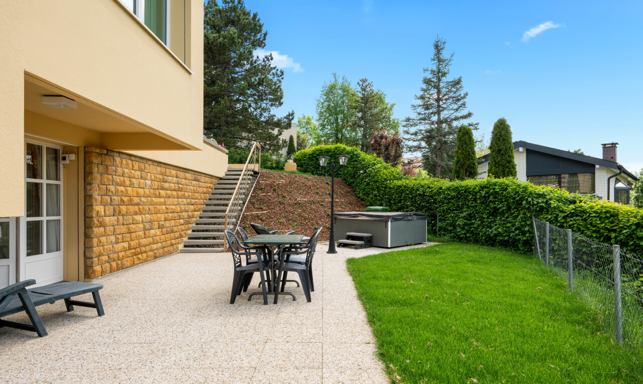 terrace with a hot tub, a patio, outdoor dining space, and a fenced backyard