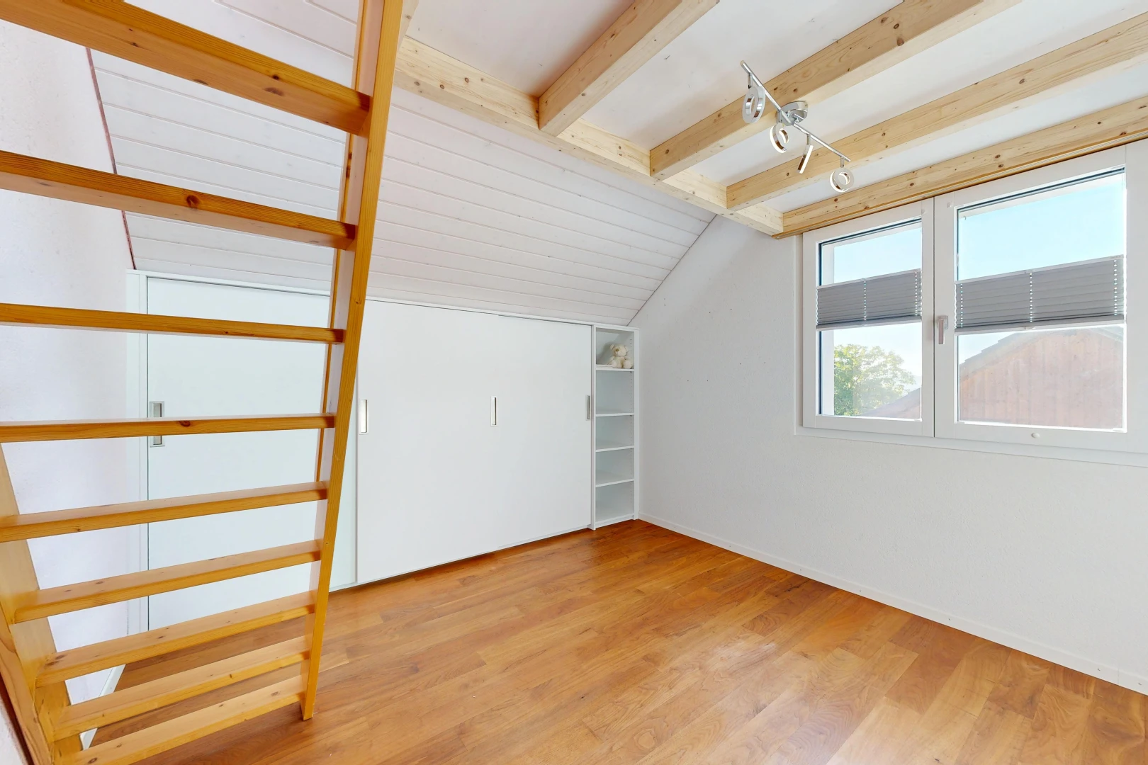 leerer raum mit zusätzliches zimmer, balkendecke, beamed ceiling, holzfußboden, und wood finish floor