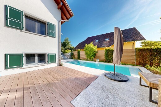 view of swimming pool featuring a wooden deck and patio surround