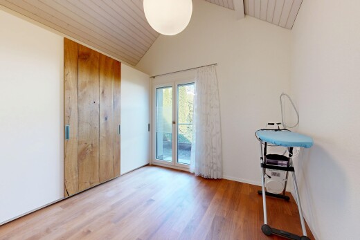unfurnished room featuring vaulted ceiling, light wood-style flooring, and access to exterior