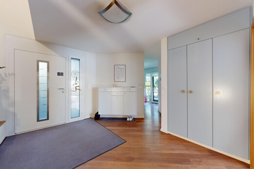 hall featuring access to exterior, wood finished floors, and a closet