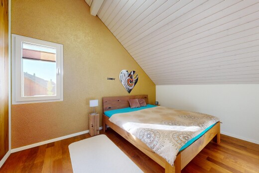 room with lofted ceiling and wood finished floors