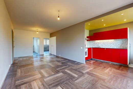 empty room with parquet flooring and pendant lighting