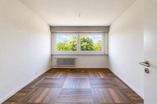 pièce vide avec radiateur, drywall, cloison sèche, wood finish floor, et sol en finition bois