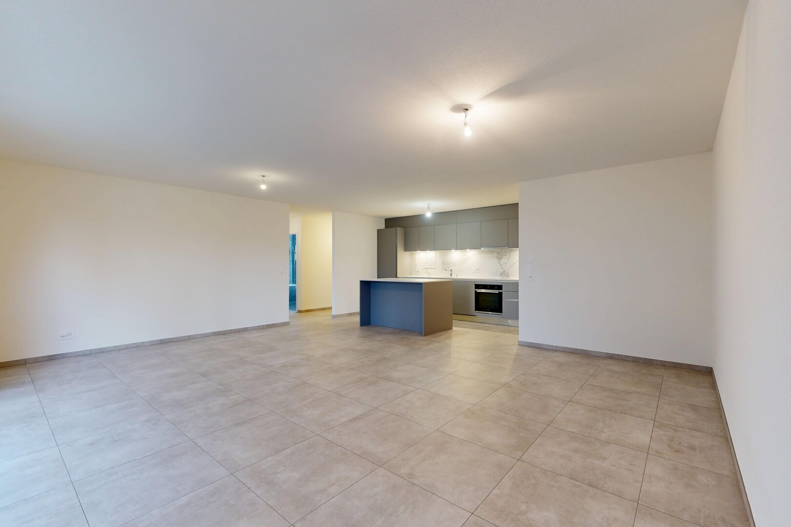 salon avec inside property, cloison sèche, drywall, light floor, et l shaped kitchen