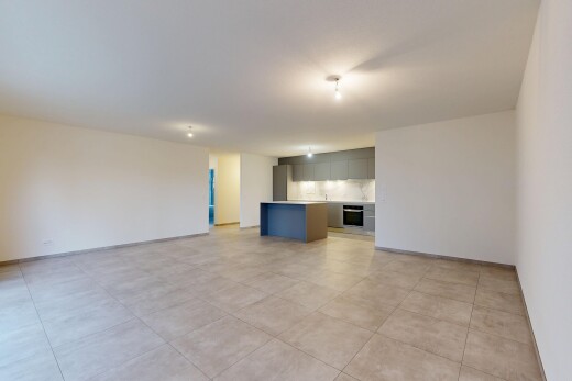 salon avec inside property, cloison sèche, drywall, light floor, et l shaped kitchen
