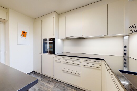 cuisine avec plans de travail, four, cloison sèche, drywall, et inside property