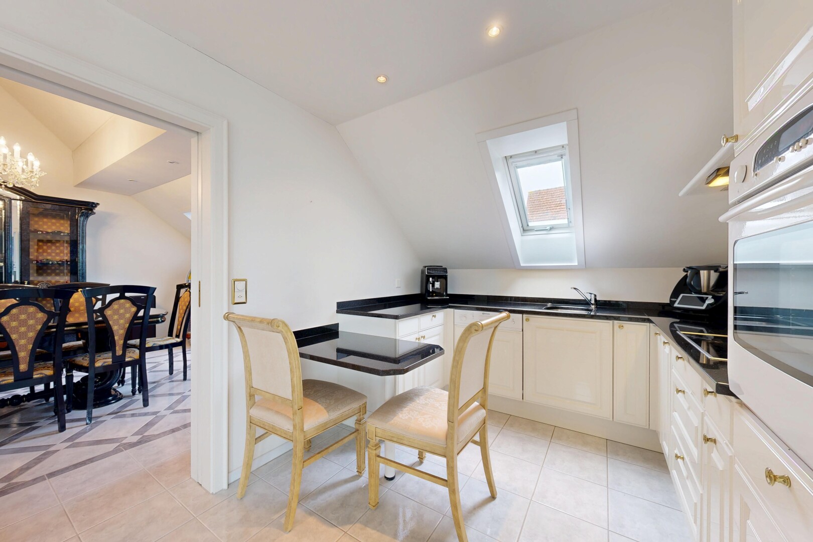 cuisine avec plafond voûté, vaulted ceiling, four, light floor, et dark countertops