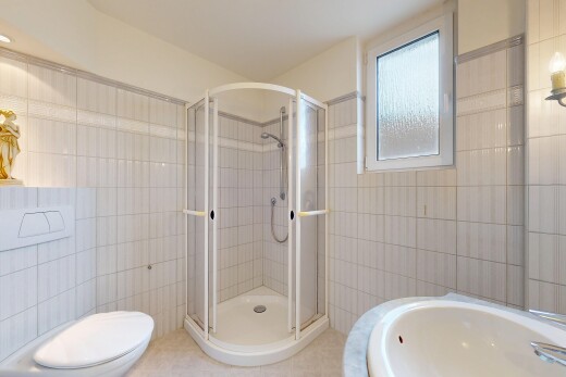 bathroom with tile walls and a shower stall