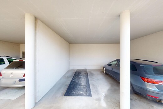 view of parking featuring a parking garage