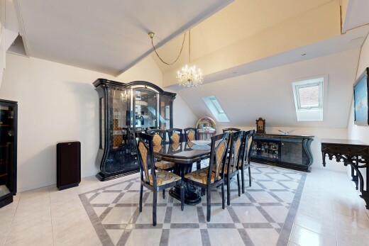dining room with inlaid floor details, hanging lights, vaulted ceiling, light tile patterned flooring, and a skylight
