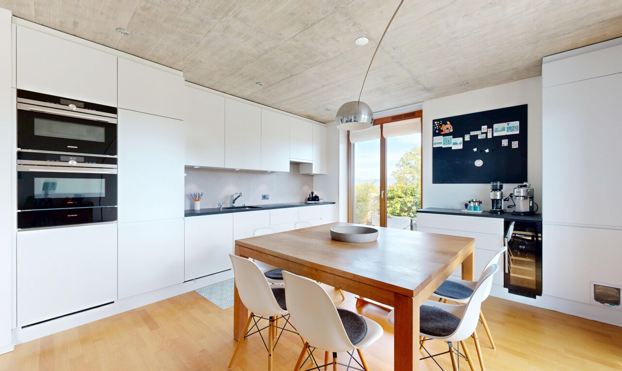 kitchen with double oven, white cabinets, dark countertops, and modern cabinets