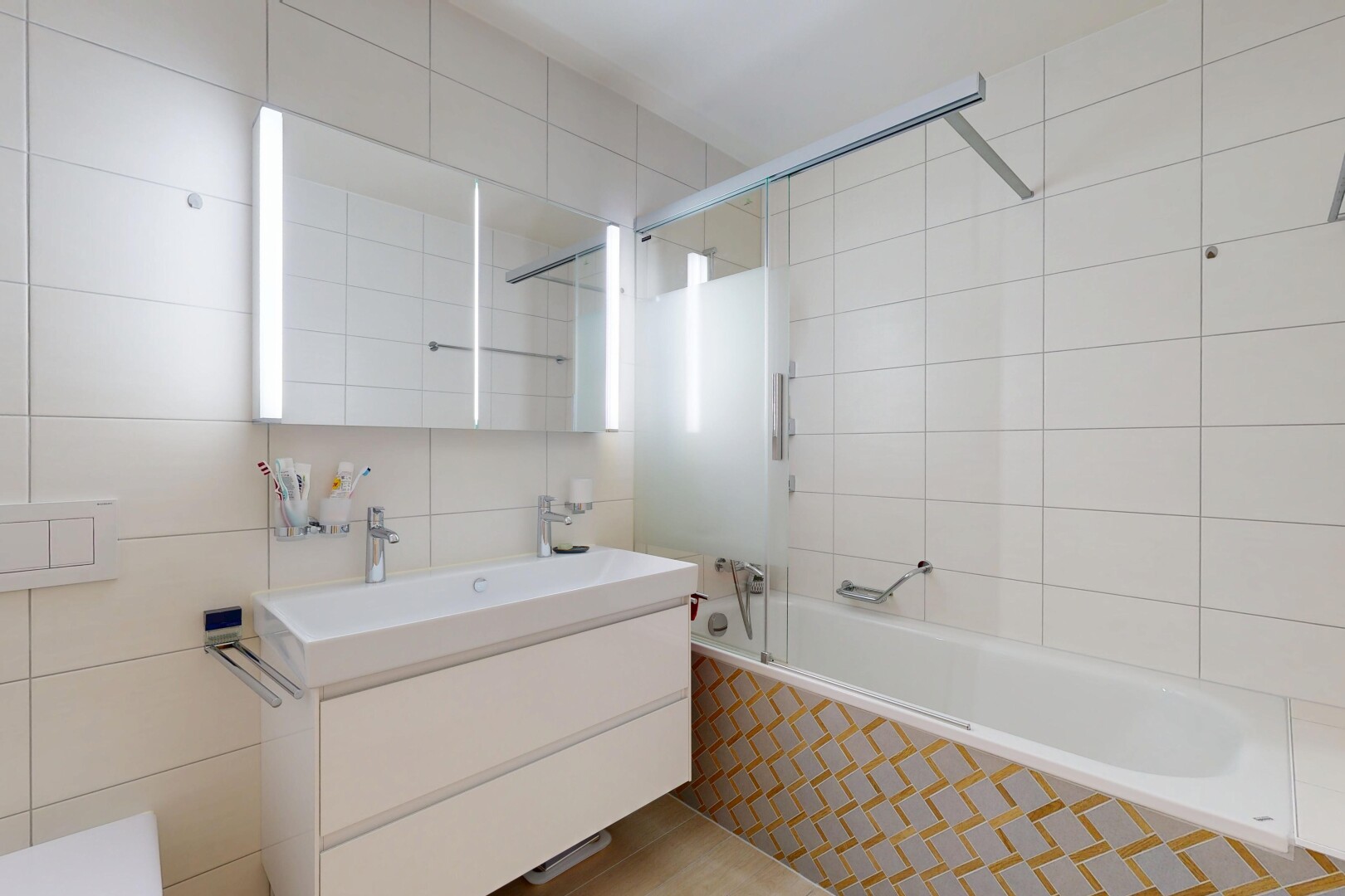 bathroom featuring tile walls, tiled shower / bath combo, and vanity