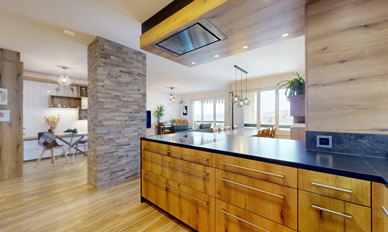 kitchen with decorative light fixtures, brown cabinets, a chandelier, and light wood-type flooring