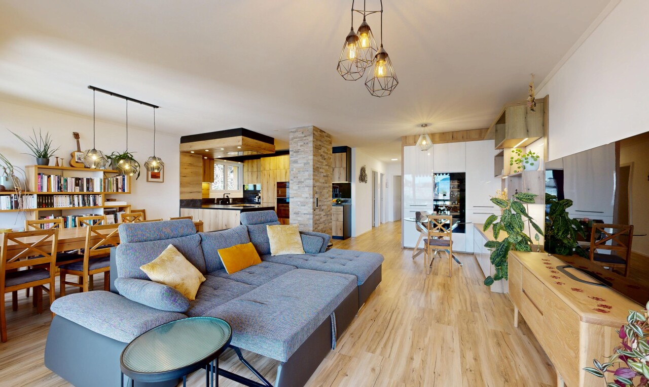 living / dining room featuring light wood-style flooring and a chandelier