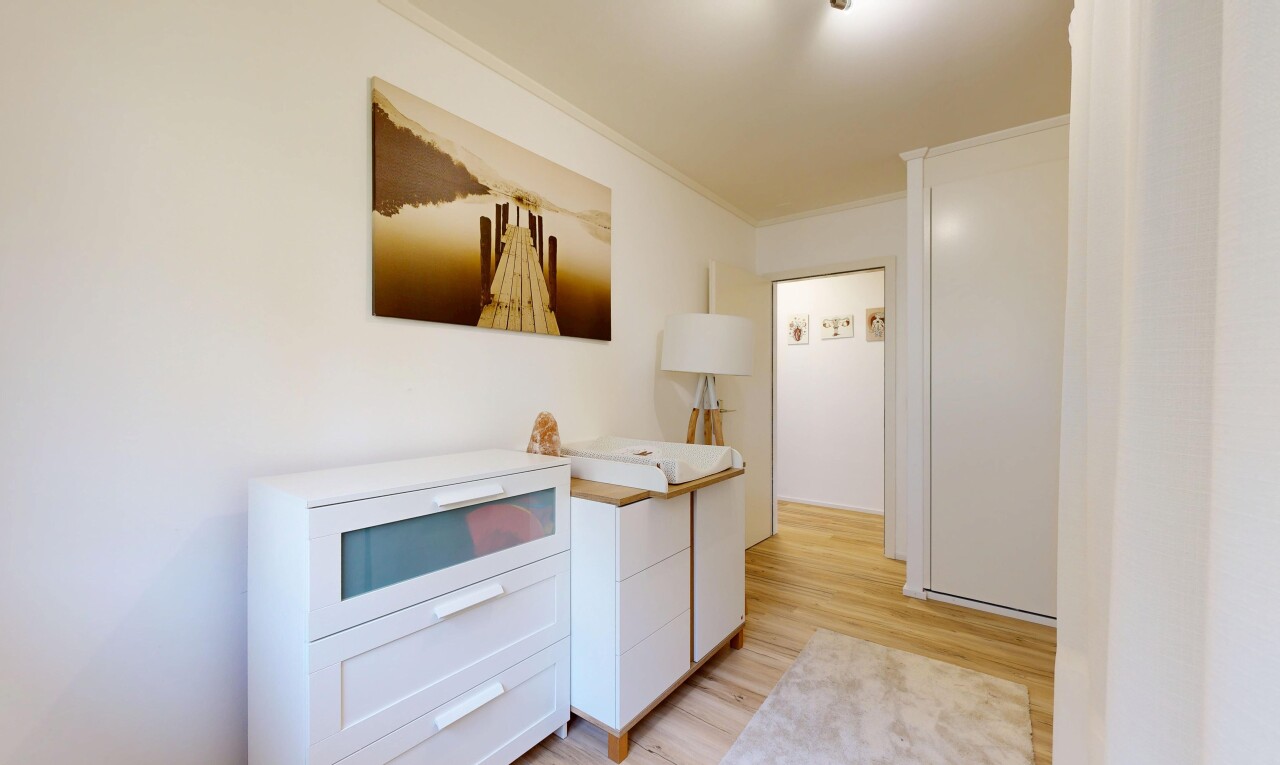 kitchen featuring light wood-style floors, ornamental molding, and white cabinetry