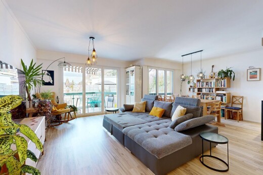 living area with a chandelier, light wood finished floors, and plenty of natural light