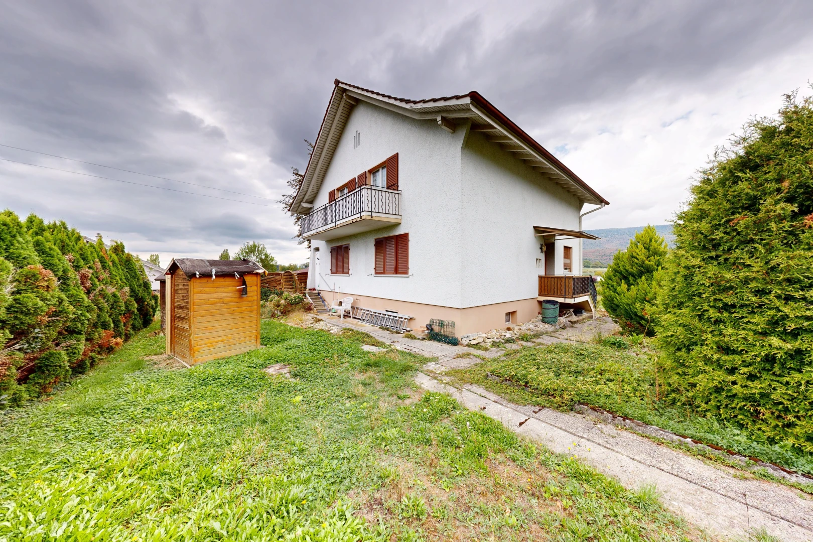 view of home with a balcony and stucco siding