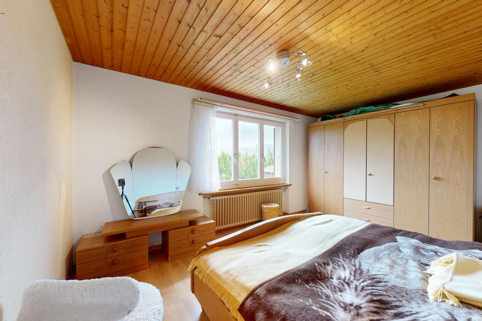 room / bedroom with rail lighting, wood ceiling, radiator, a closet, and light wood-style flooring