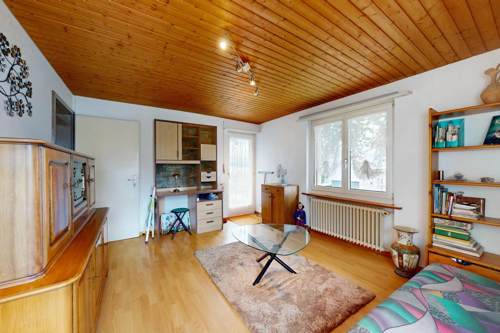 living room featuring rail lighting, wood ceiling, radiator heating unit, access to outside, and an office area