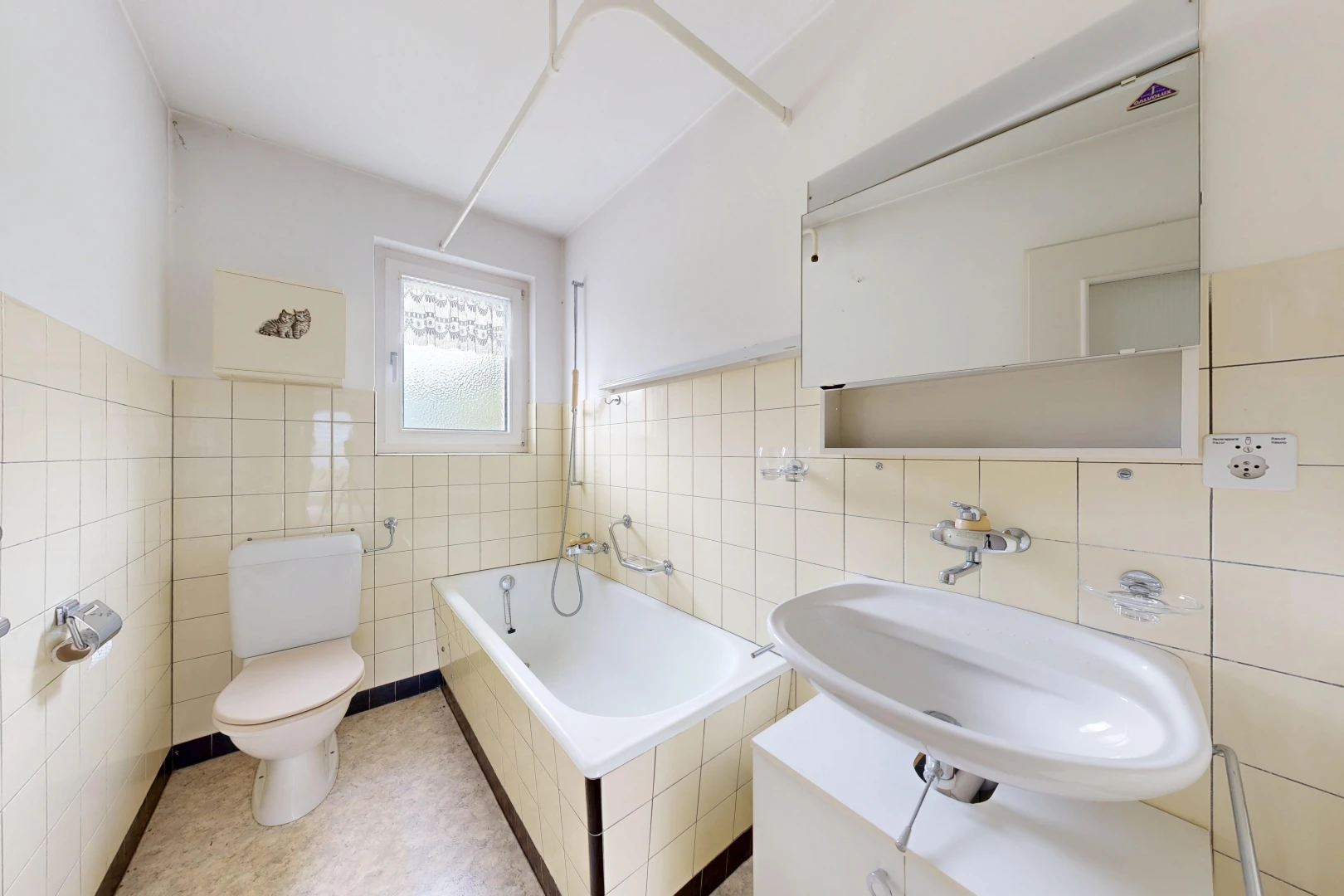bathroom featuring a relaxing tiled tub, tile walls, and wainscoting