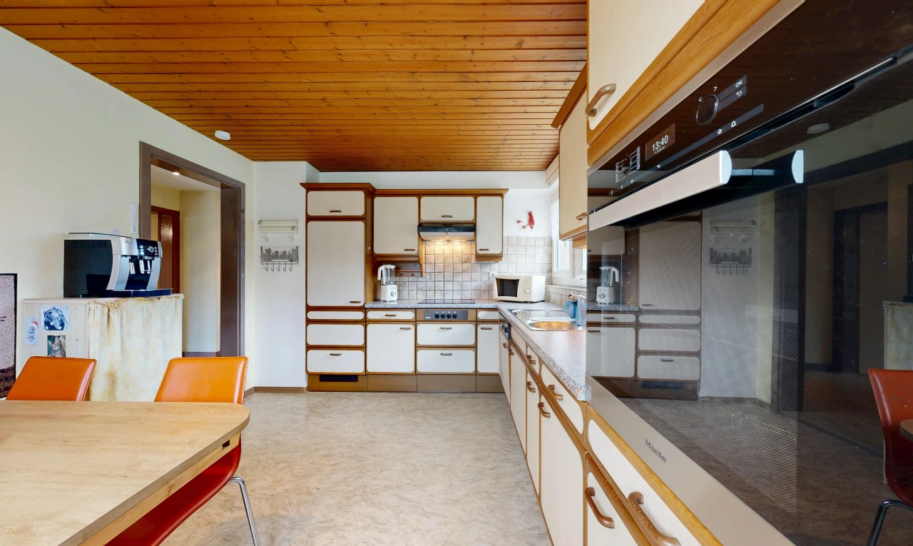 dual tone kitchen featuring oven, wooden ceiling, dual tone cabinetry, tasteful backsplash, and light countertops