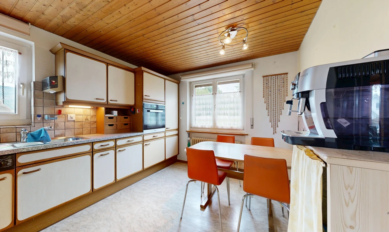 kitchen featuring wooden ceiling, light countertops, two tone color scheme, tasteful backsplash, and oven