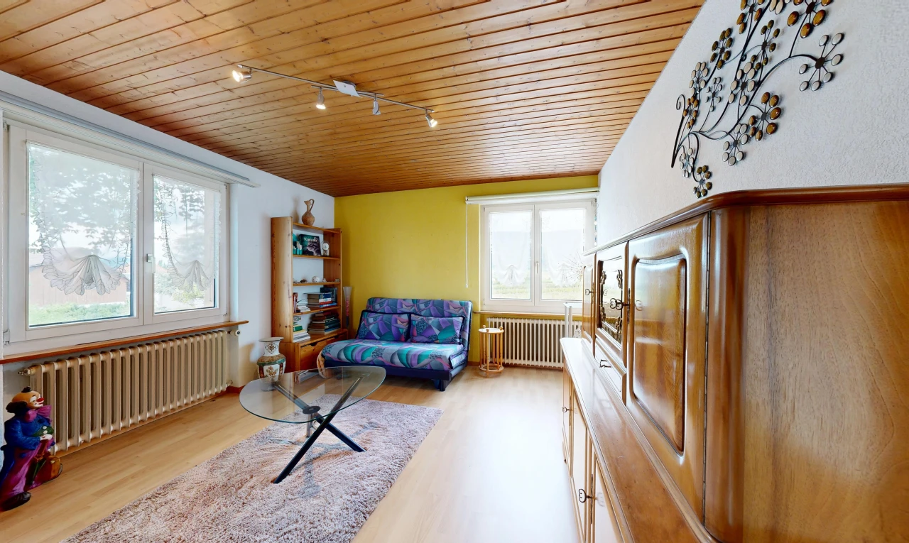 living room with rail lighting, radiator heating unit, wooden ceiling, radiator, and healthy amount of natural light
