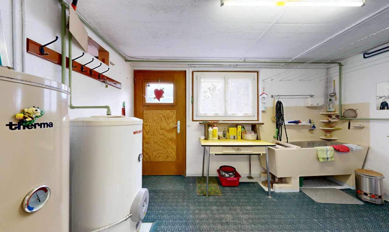 laundry room featuring gas water heater, water heater, and access to outside
