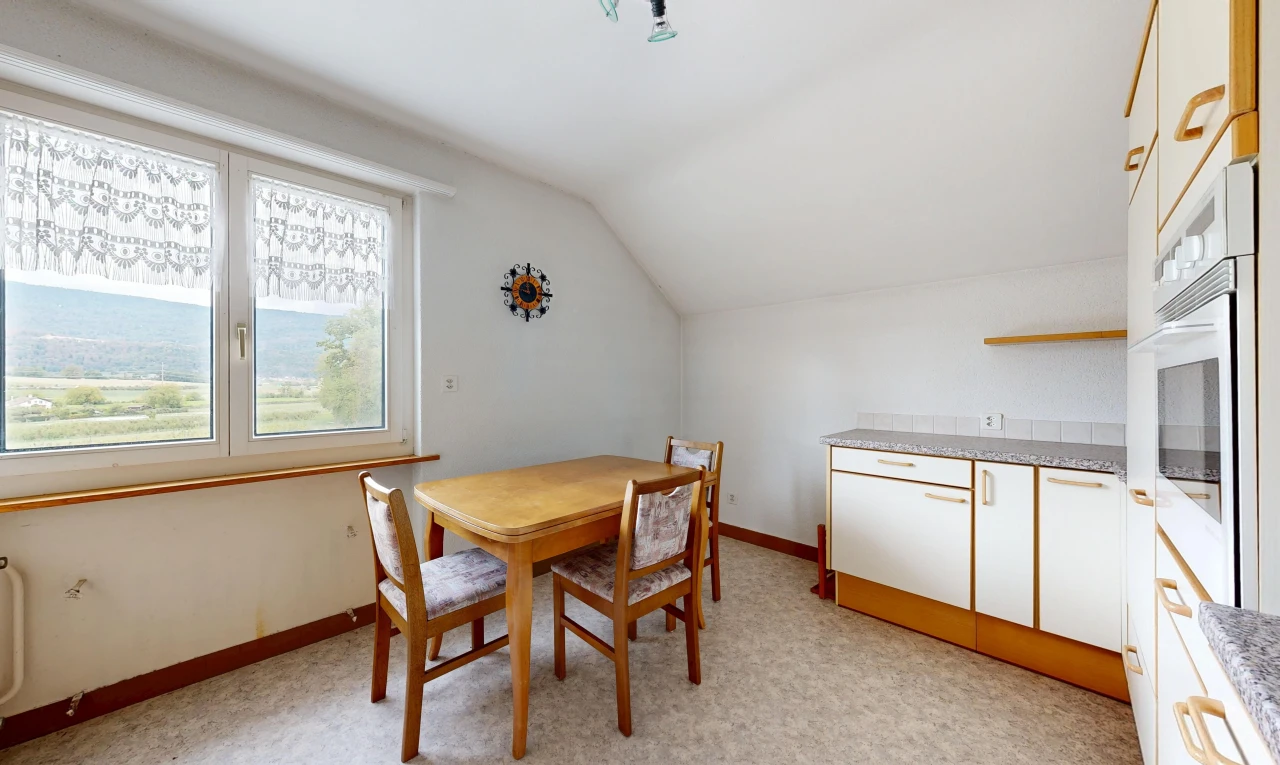 dining room with lofted ceiling and baseboards