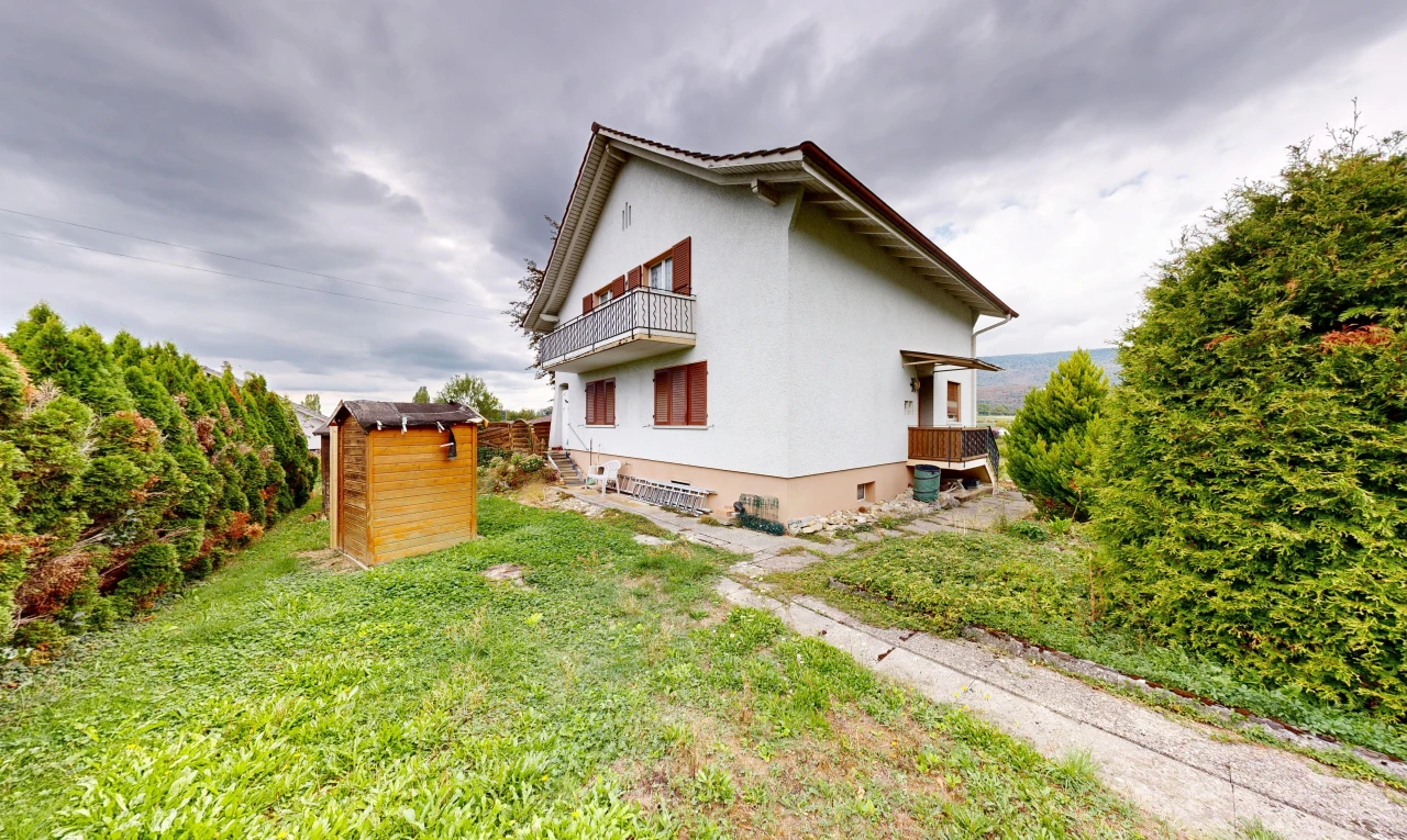 view of home with a balcony and stucco siding