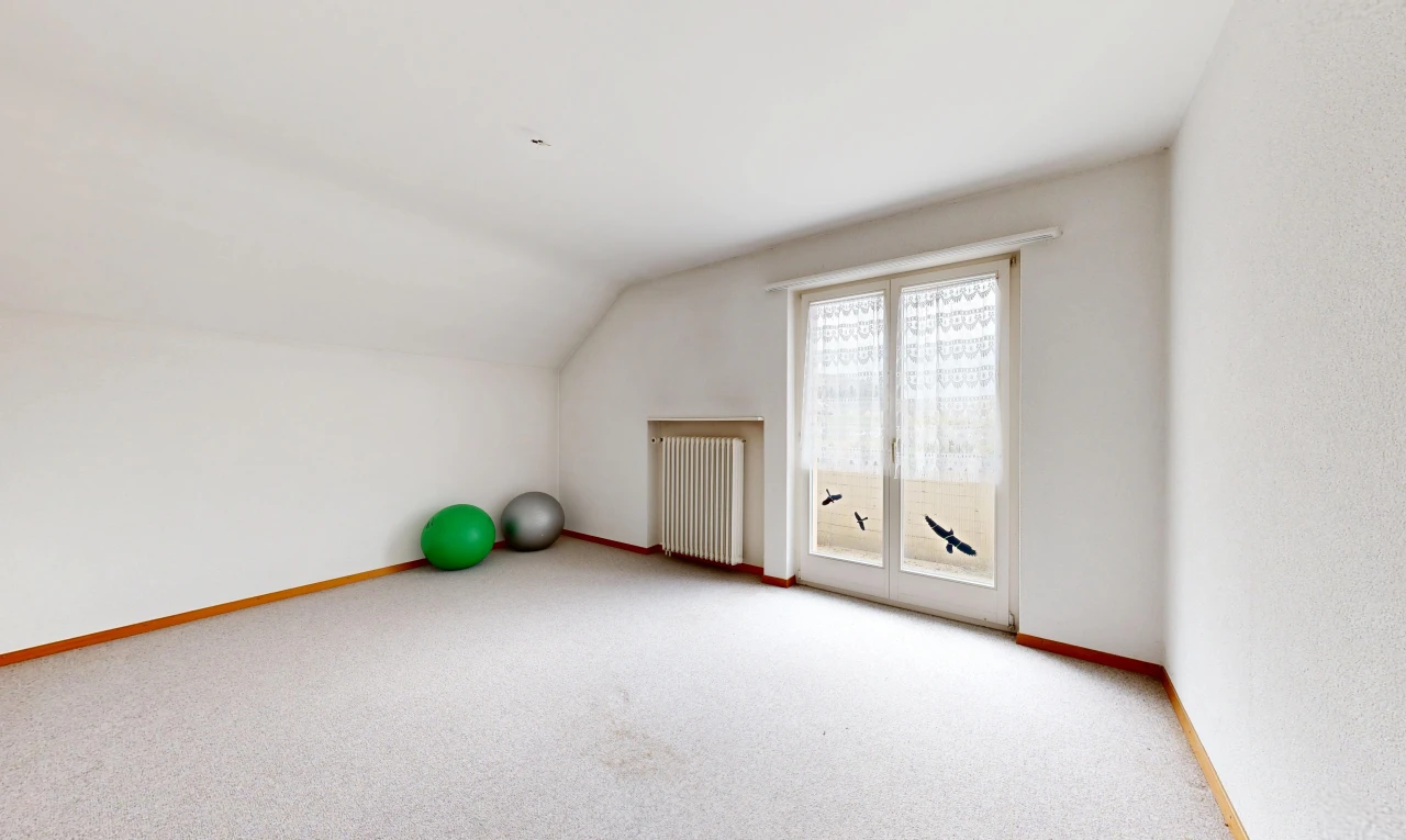 unfurnished room with radiator, vaulted ceiling, and light carpet