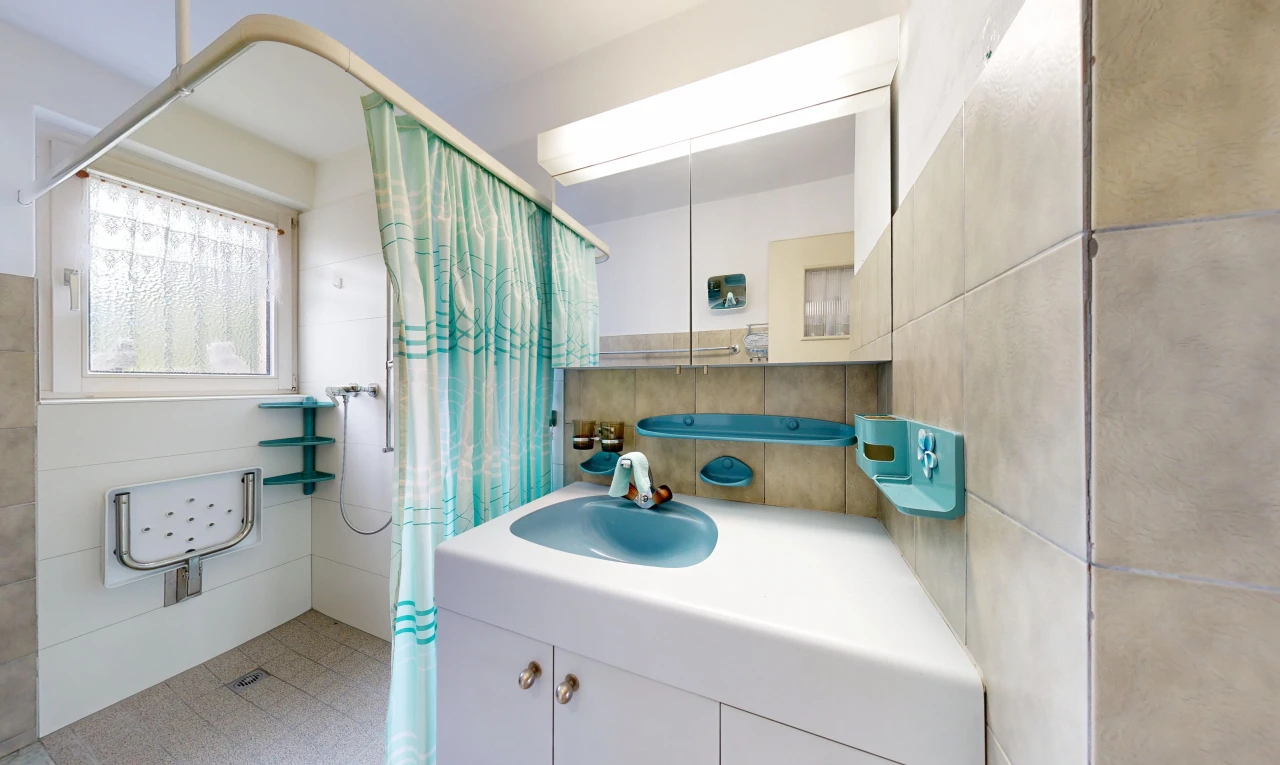 bathroom with curtained shower and vanity
