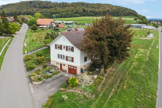 view of home featuring an attached garage and asphalt driveway
