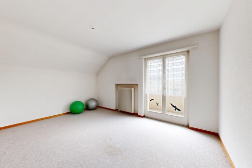 unfurnished room with radiator, vaulted ceiling, and light carpet