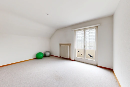 unfurnished room with radiator, vaulted ceiling, and light carpet