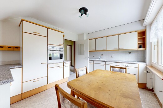 kitchen with open shelves, light countertops, and white oven