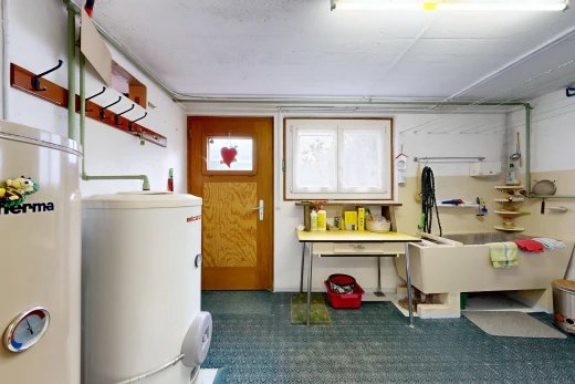 laundry room featuring gas water heater, water heater, and access to outside