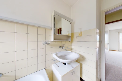 full bath with tile walls and a bathtub