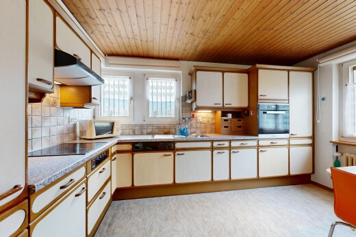 kitchen featuring light countertops, two tone cabinets, oven, wooden ceiling, and white microwave