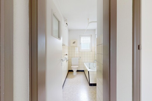 bathroom featuring a garden tub, tile walls, and wainscoting