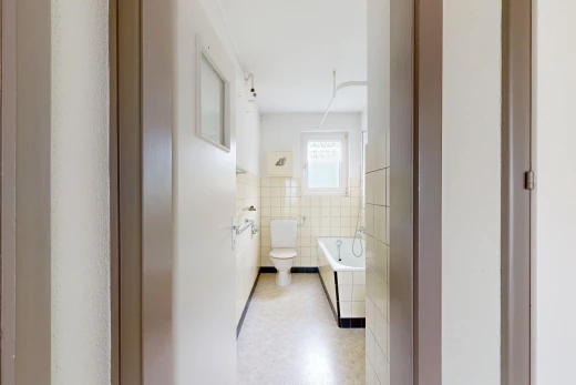 bathroom featuring a garden tub, tile walls, and wainscoting