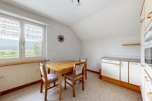 dining room with lofted ceiling and baseboards