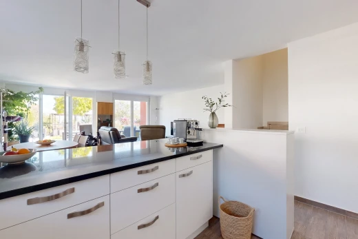 cuisine avec white cabinets, armoires blanches, éclairage suspendu, dark countertops, et plans de travail